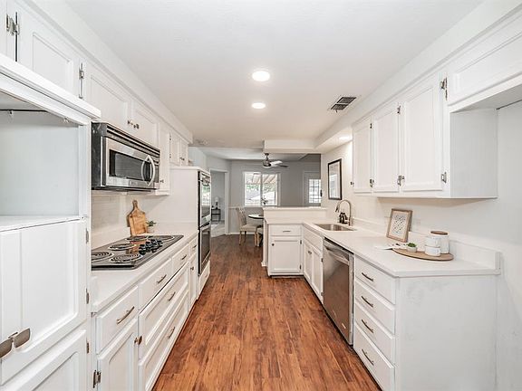 Into kitchen. long view from dining area.
