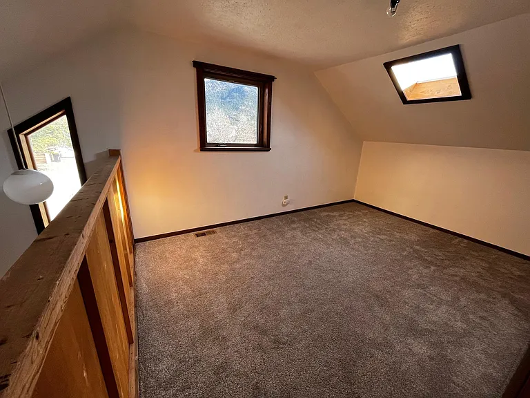 Upstairs bedroom 1, has half wall open to staircase