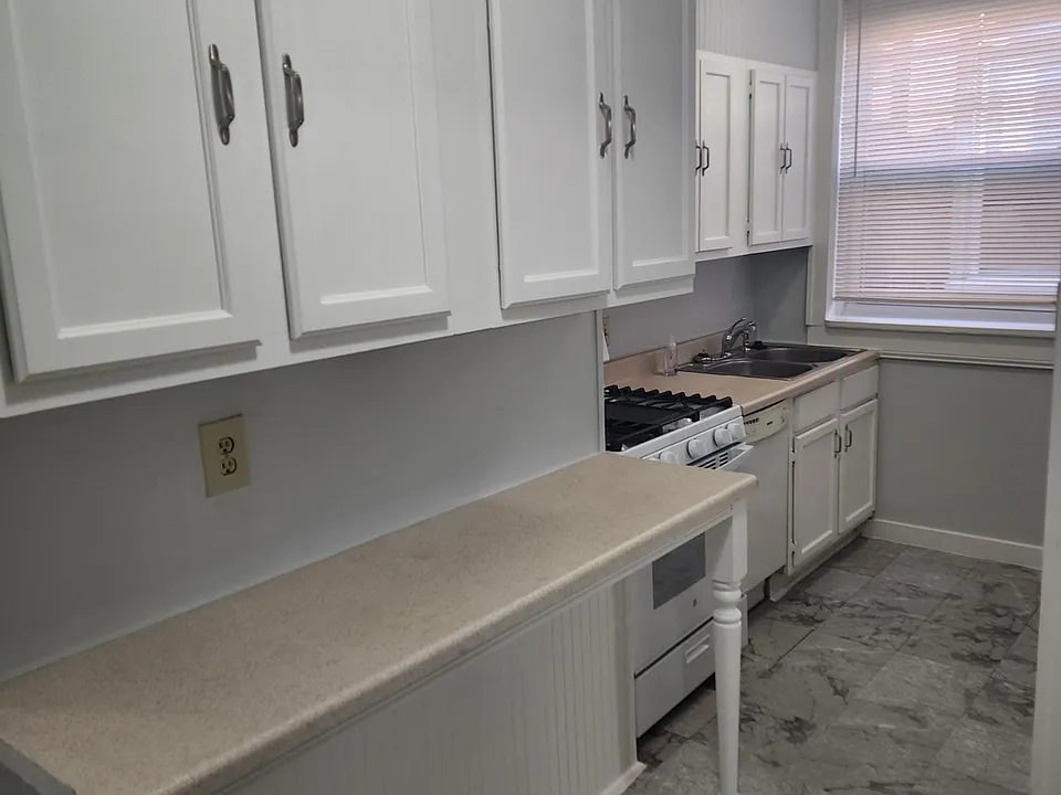 Other side of the kitchen with new stove and dishwasher