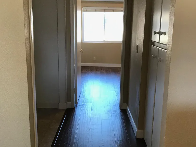 Hallway with washer/dryer room (left)