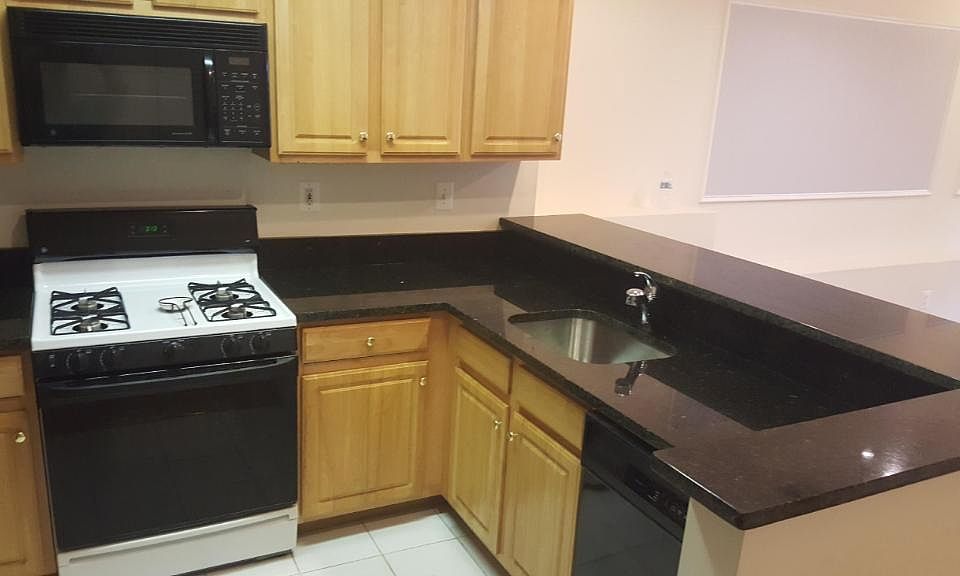 Kitchen with built-in microwave, gas stove, dishwasher and fridge