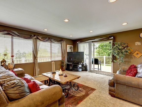 Relaxing living room with a walk out to the deck overlooking your 1 acre yard!