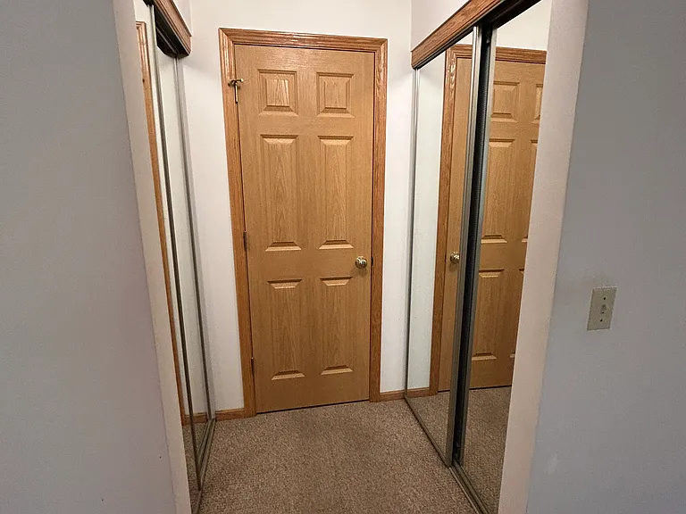 Main bedroom closets and door to half bathroom