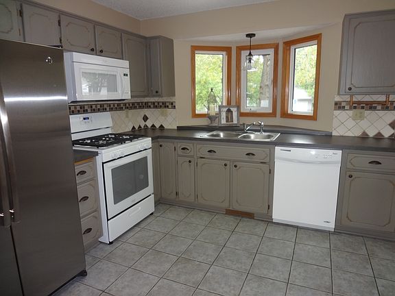 The kitchen is freshly updated with new appliances, tile flo