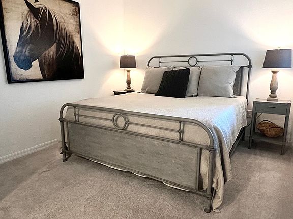 Master Bedroom with king bed, two night stands, walk-in closet and chest of drawers