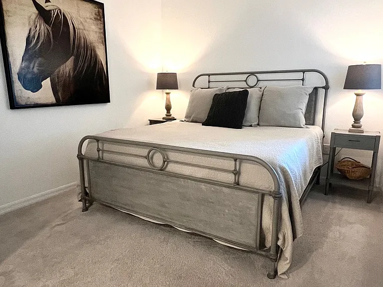 Master Bedroom with king bed, two night stands, walk-in closet and chest of drawers