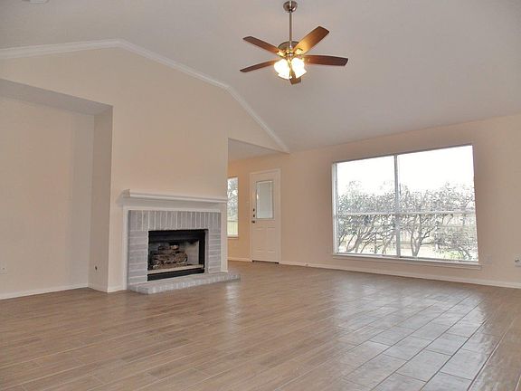 Bright, open living room with a view to the backyard. Tall c