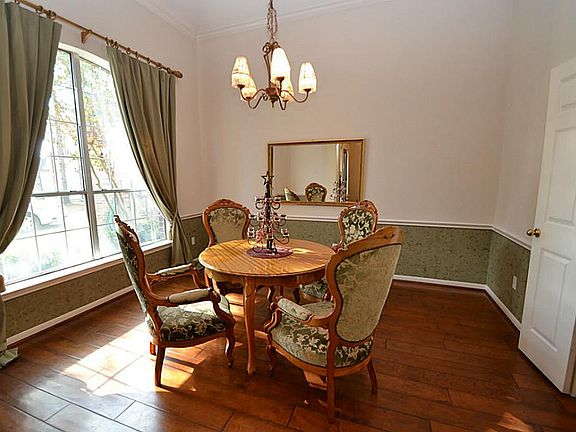 Dining room enhanced by hardwood floors, gambrel ceilings, crown molding, chair rails and access to the kitchen.