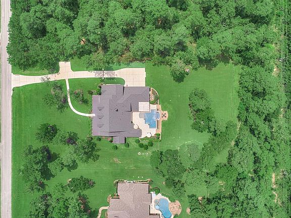 Located on a beautifully landscaped lot the home has lots of privacy and shows impeccably inside and out. The home had a new roof added in 2020, new negative edge pool added 2019 and shows like a new construction home. Simply gorgeous!