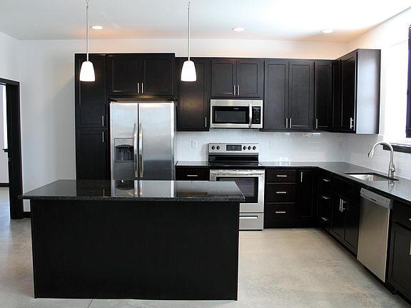 Granite countertops and stainless steel appliances.