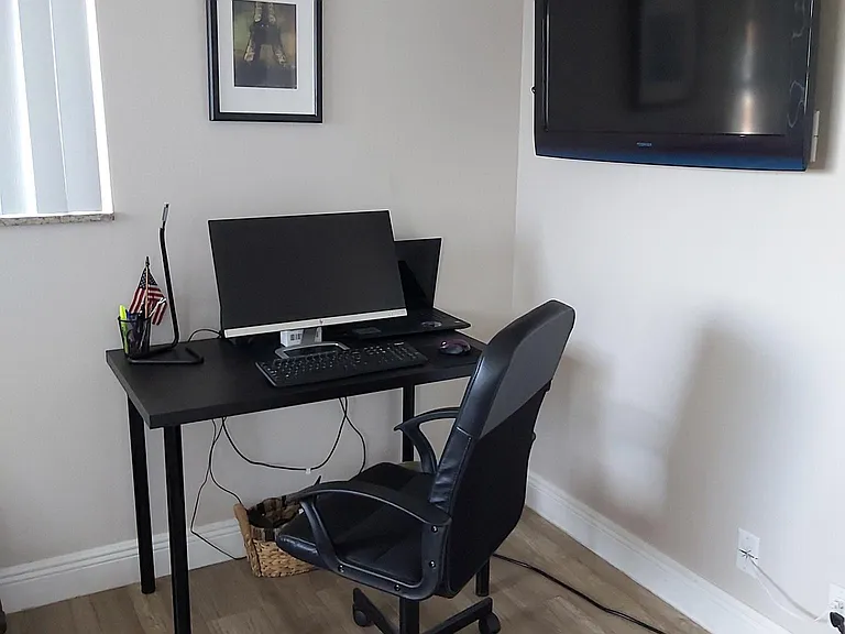 Bedroom with desk, and TV