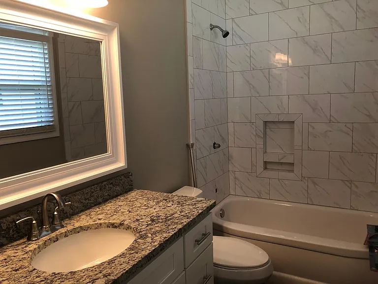 Master bathroom with granite countertops and carerra marble