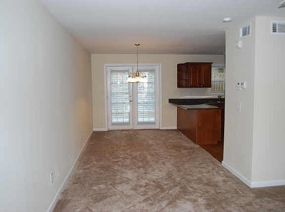 Open floor plan from liv.room to dining room with access to the private patio.