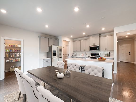 The dining table fits perfectly at the heart of the open-concept living area.