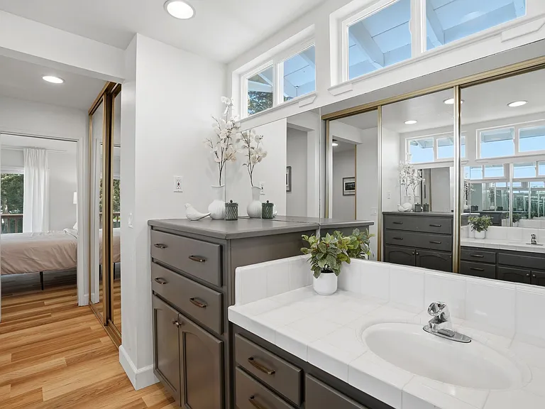 Primary bath upstairs features tons of built-in storage, dual sinks and extra closet space too