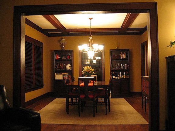 dining room with box beam ceilings
