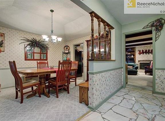 Formal dining with hardwood floor under carpet.
