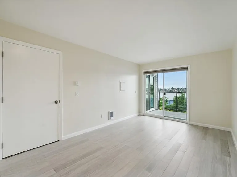 bedroom w/ wood floors & view
