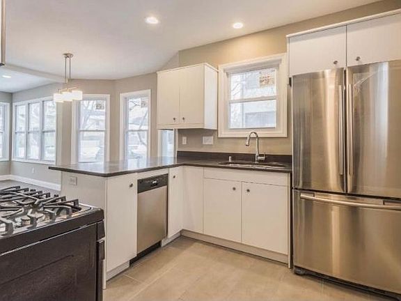 Kitchen with Gas Stove, Dishwasher, Refrigerator, Microwave. Flooring has been updated since photo.