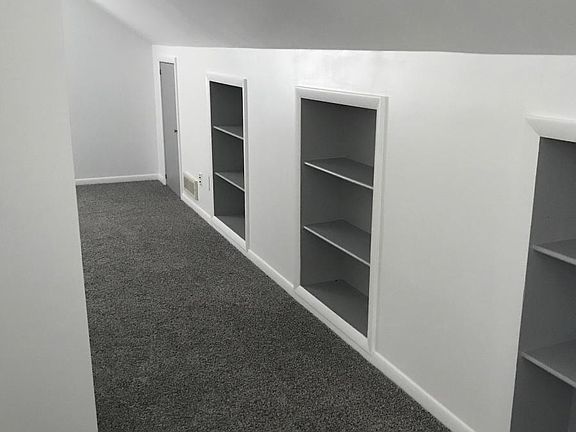 Upstairs den / library with built on bookshelves. New paint