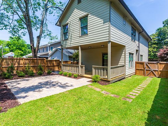 Fenced in back yard with giant covered patio