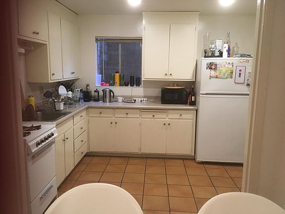 Kitchen with plenty of cabinet and countertop space, gas stove, large fridge, space for a dining table, access to the deck.