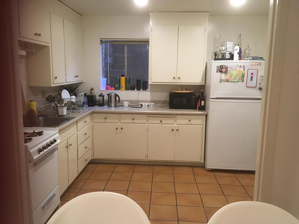 Kitchen with plenty of cabinet and countertop space, gas stove, large fridge, space for a dining table, access to the deck.