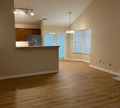 Vaulted ceiling with kitchen overlooking family room. New LVP flooring throughout entire house.