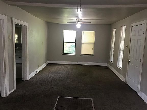 Living room looking north, front door on the right. You can see the kitchen on the left.