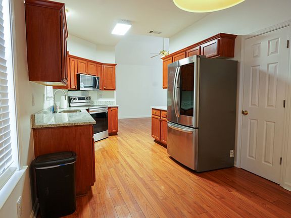 Kitchen with all stainless-steel appliances, new granite countertops. Hardwood floors throughout the house.