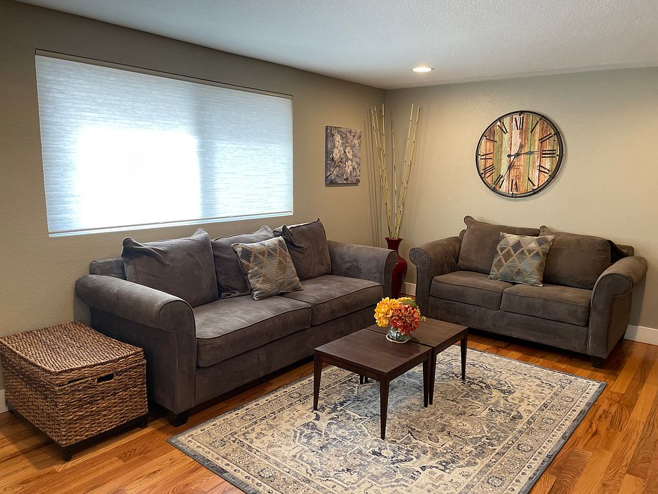 Family room with true hardwood floors and custom cellular blinds