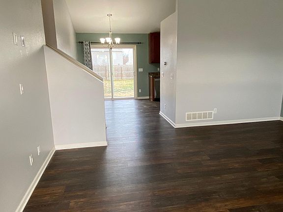 main floor living room w view of dining room and backyard