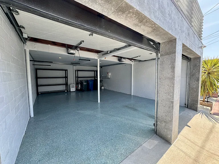 2 car garage with storage and with an additional parking spot in front of the garage doors. EV charger in garage.