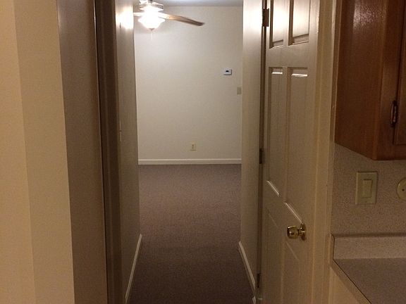 Hallway to the living room, bathroom on left, furnace room o