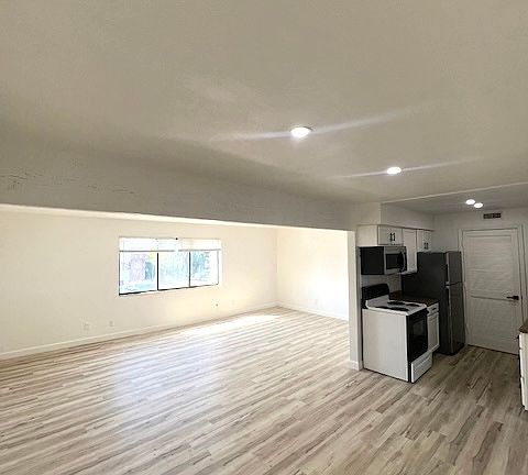 Galley style kitchen with Dishwasher, refrigerator, microwave and pantry.