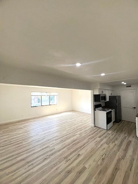Galley style kitchen with Dishwasher, refrigerator, microwave and pantry.