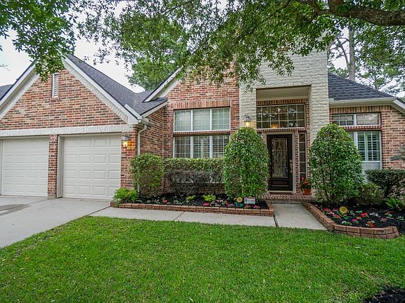 Well maintained landscaping, trees, and a beautiful brick elevation.