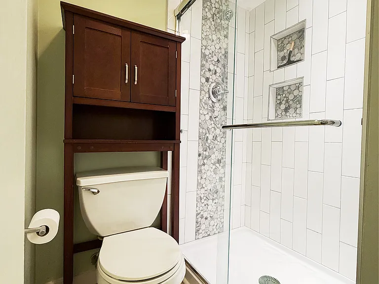 Primary Bathroom _ Glass Shower
Beautifully updated primary bathroom featuring a walk-in glass shower with custom tile detail and built-in niches