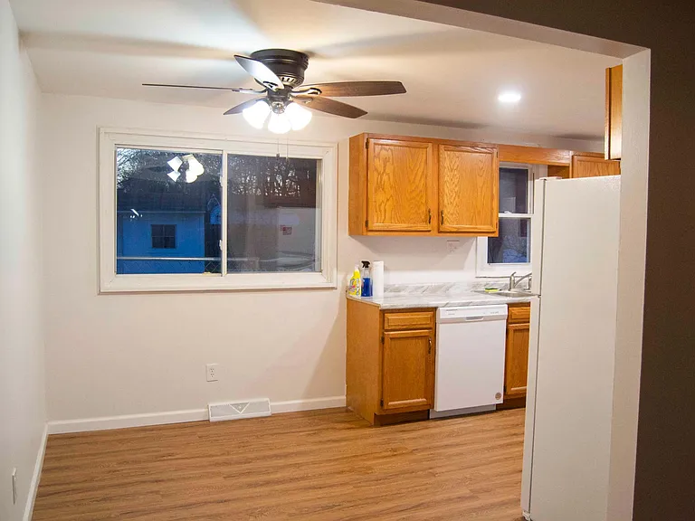 Fan, lights, floor, sink, faucet, and appliances.