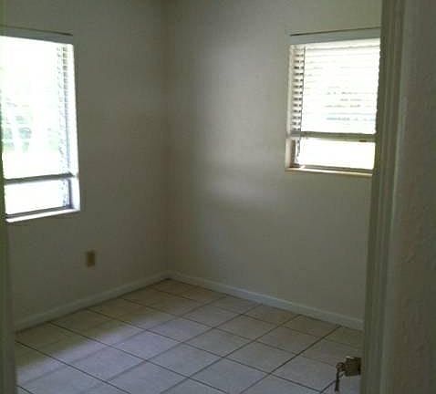 Back bedroom, lots of light tiled throughout
