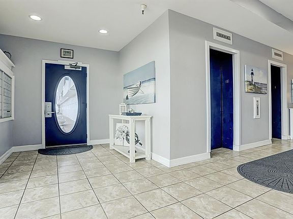 THE COMMON AREA ENTRANCE ALSO FEATURES MAIL BOXES AND 2 SEPARATE ELEVATORS TO ALL LEVELS.