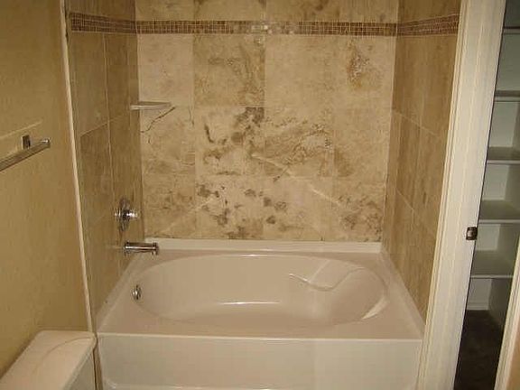 Upstairs Bathroom with Travertine Floors and Shower Surrounds