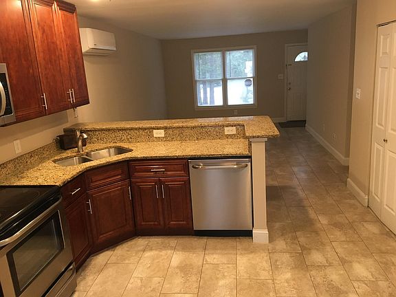 Looking from kitchen to living room. Laundry area on right that opens to kitchen.
