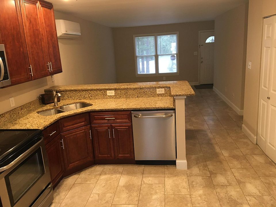 Looking from kitchen to living room. Laundry area on right that opens to kitchen.