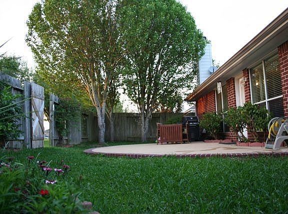 Mature landscaping and circular patio, brick on all four sides
