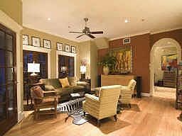 A view of the second floor living room facing the french doors that open above the patio area. Open 