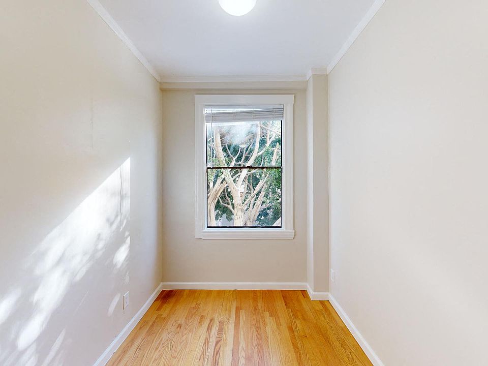 Bedroom with a window and a wood-like floors