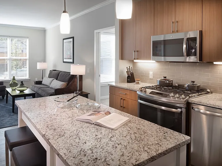 Traditional Collection Kitchen with oak cabinetry, beige tile backsplash, grey granite countertops, stainless steel appliances, and hard surface flooring