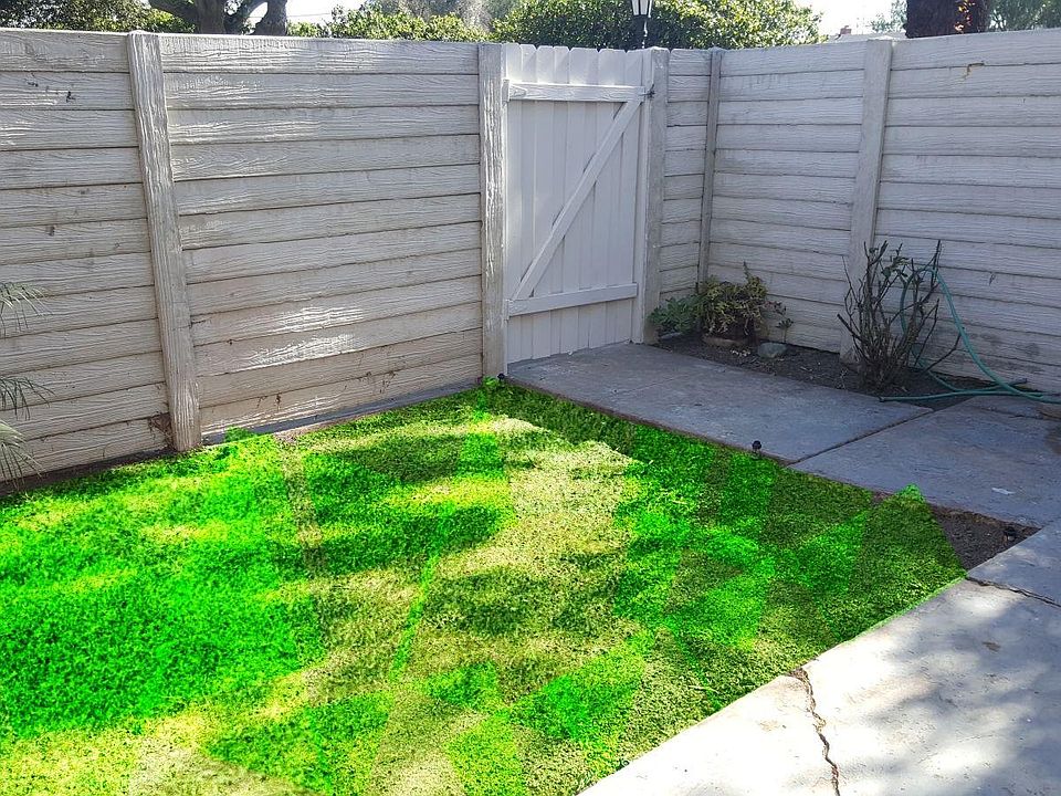 Grassy Backyard with private gate leading to carport. Additi