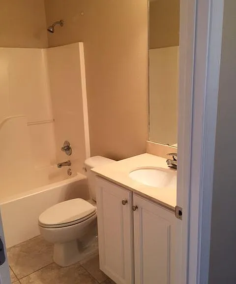 A full guest bathroom sits conveniently down the hall from the second bedroom.